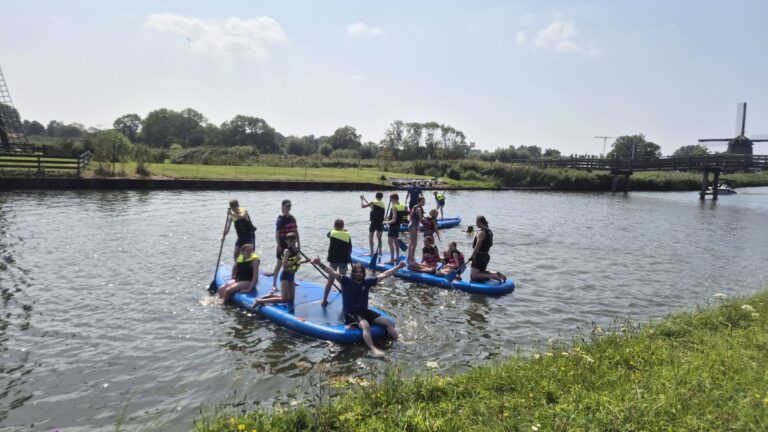 Aventuras Zomerkamp bij Indoor Beach Alkmaar. De kinderen varen op drie sups.